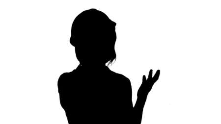 Silhouette Female engineer with orange helmet having a phone call via smartphone track matteの写真素材