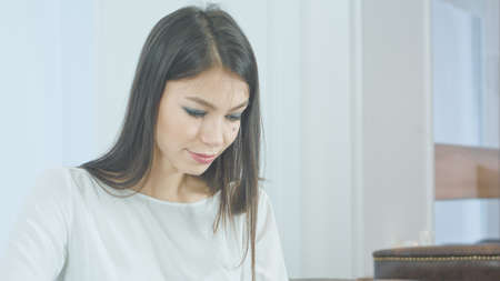 Concentrated young woman using tablet pcの写真素材