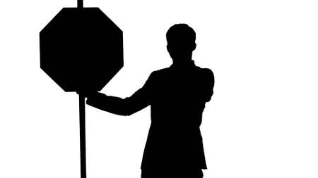 Silhouette A businessman holding a stop sign on laptop.の写真素材
