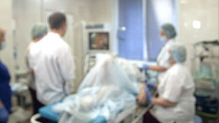 Doctors and nurses performing endoscopic procedure in hospitalの写真素材