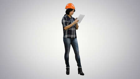 Asian engineer woman using tablet on white backgroundの写真素材