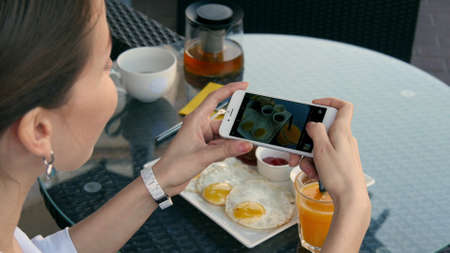 Woman take photo on her foodの写真素材