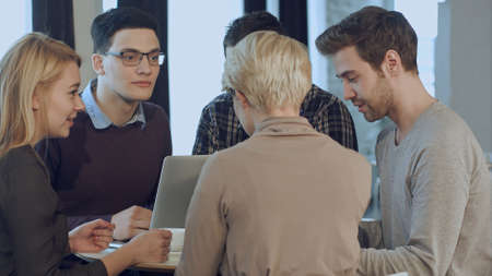 Creative people doing a brainstorming meeting in a modern studioの写真素材