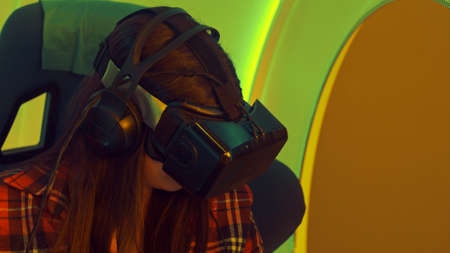 Excited girl enjoying virtual reality attractionの写真素材