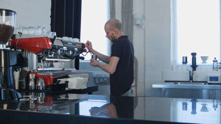 Professional work of barista, preparing milk for coffeeの写真素材