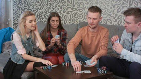 Friends are playing poker game, dealing the cards and bettingの写真素材