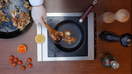 Decorating prepared paellaの写真素材