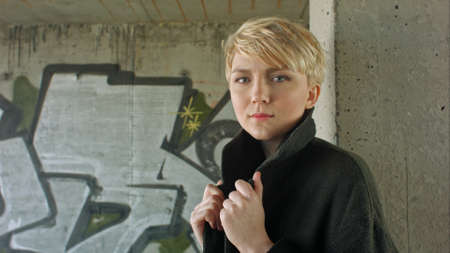 Young blond girl with modern haircut posing.の写真素材