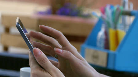 Female hands touching digital tablet outdoorの写真素材
