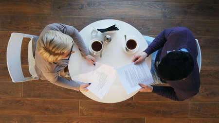 Two business people during work meeting in modern cafeの写真素材