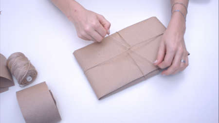 Woman wrapping present with juteの写真素材