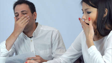 Tired business partners working during lunch at the cafeの写真素材