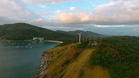 Above view of wind energy turbines near the seaの写真素材