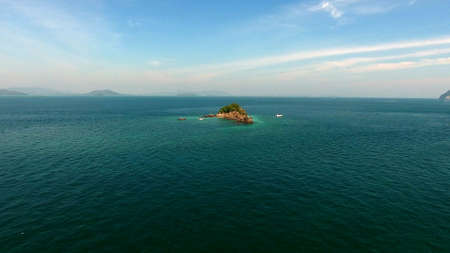 Aerial view, copter flies around the rock in the Indian ocean, near Phuket, thailand