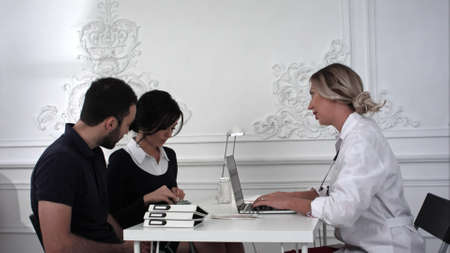 The husband and wife came for consultation to the doctor in the officeの写真素材