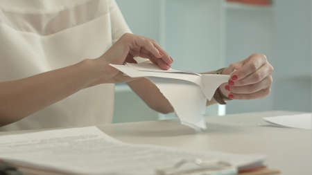 Woman tearing paper
