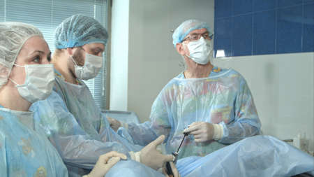 Medical staff in the opearing room doing sucessful surgical procedureの写真素材