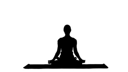 Young woman meditates while practicing yoga track matteの写真素材