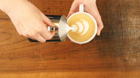 How to make latte art by barista focus in milk and coffeeの写真素材