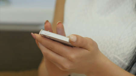 Woman fingers texting messages using cell phoneの写真素材
