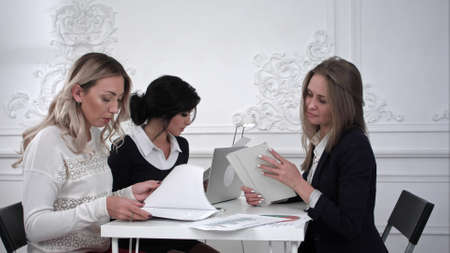 Group of young business women working with tablet in a meeting at officeの写真素材