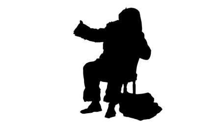 Silhouette Santa makes selfie with smartphoneの写真素材