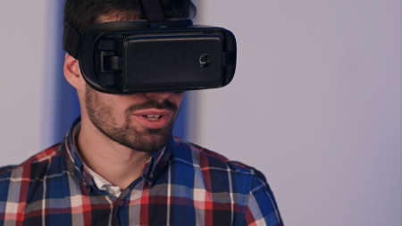 Smiling man in vr glasses looking into the camera after virtual reality session