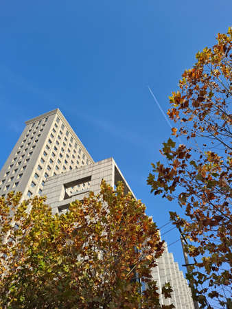 Airplane flying over tall buildingsのeditorial素材