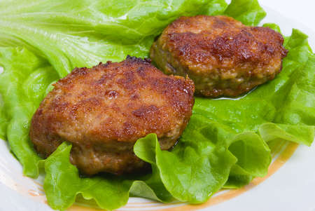 Cutlets in a plate with vegetables.green sheet of the saladの写真素材