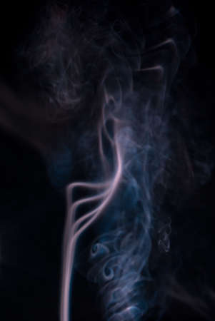 Colored smoke wisps on black background,soft patterns