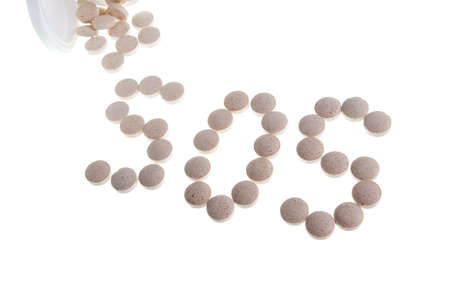 help  - Pills Spilling out of Pill Bottle closeupの写真素材