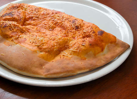 Delicious hot Calzone pizza  On a plat. Close-upの写真素材
