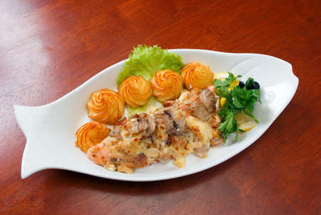 Italian kitchen.Veal with sauce and a potatoの写真素材