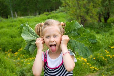 The ridiculous girl. Game with burdocksの写真素材