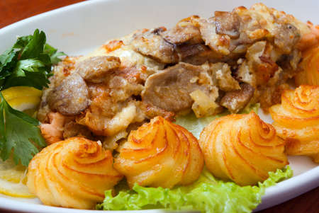 Italian kitchen.Veal with sauce and a potato.close upの写真素材