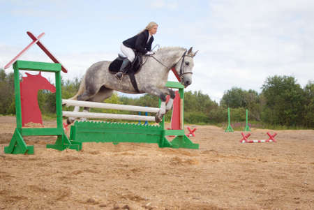 show jumping.girl riding horse and jumpingの写真素材