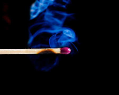 Smoke from a match that was just put out .close-up.
blue smoke over black background