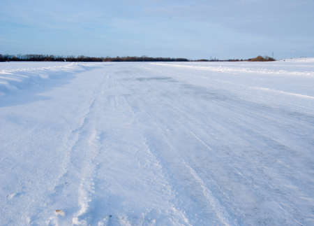 Snowy country lane.winter freeway.snow-clad riverの写真素材