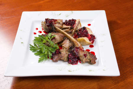 Italian kitchen.meat lamb on rib with cowberries by sauceの写真素材
