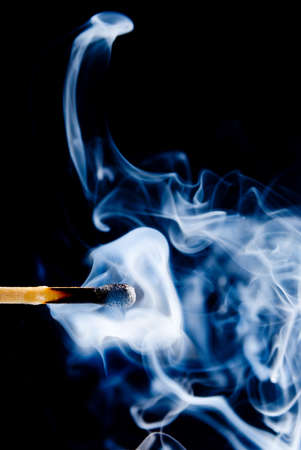 Smoke from a match that was just put out  on a black backgroundの写真素材