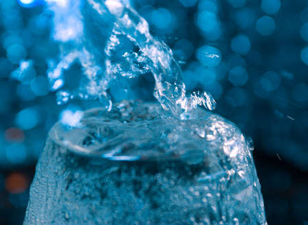 Water being poured into a glass.Glasses with creative splashing waterの写真素材