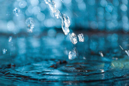  creative splashing water.Macro of water poured into a glass of water 