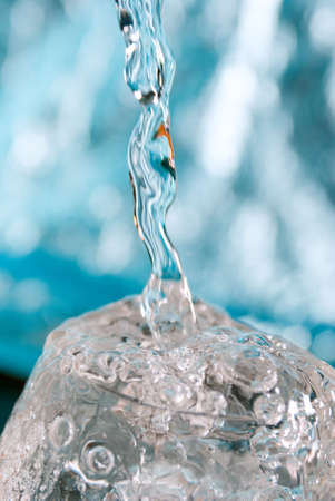 Macro of water poured into a glass