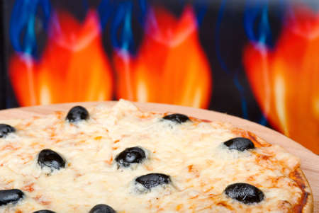 Pizza and italian kitchen with fire on backgroundの写真素材