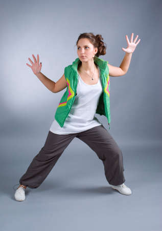 Hip hop female performing on  gray background