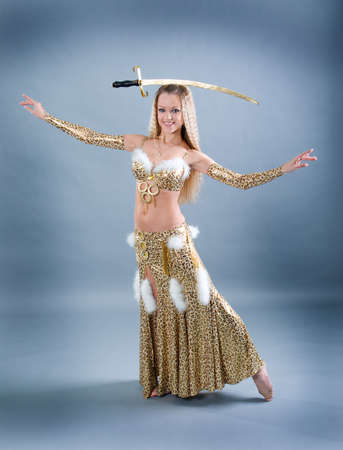 Attractive woman performing arabic dance with sabreの写真素材