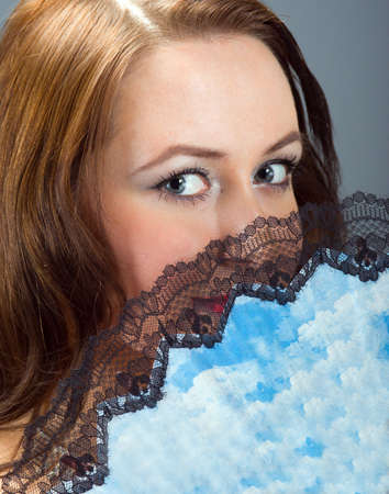 beautiful and sexy brunette girl with fanの写真素材