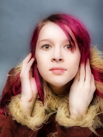 Emo look   girl with red hair on  gray backgroundの写真素材