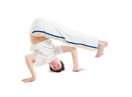   capoeira dancer posing  over white background の写真素材