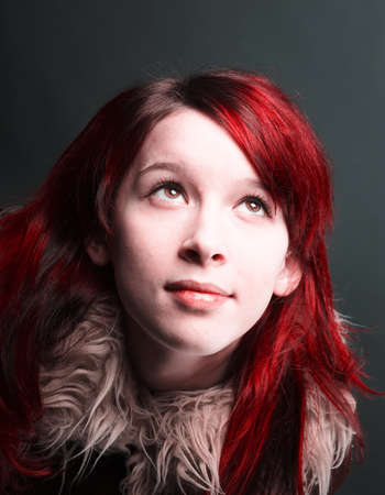    girl with red hair on  gray backgroundの写真素材